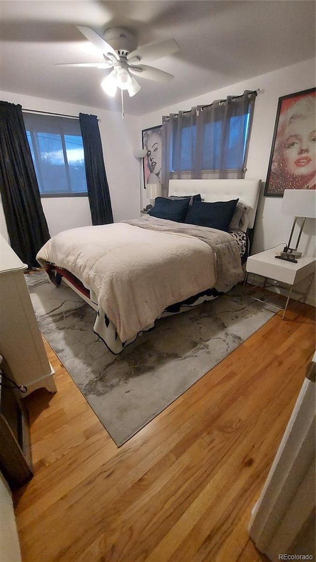 bedroom with wood finished floors and ceiling fan