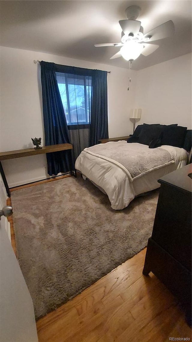 bedroom featuring a ceiling fan and wood finished floors