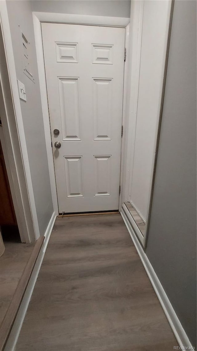 interior space featuring wood finished floors and baseboards