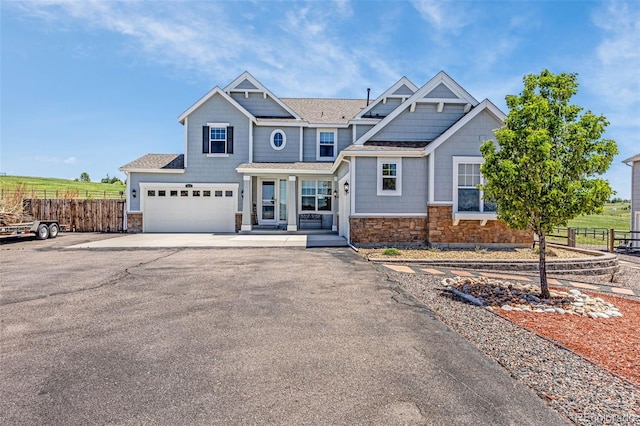 3434 Antelope Ridge Trl, Parker, CO 80138 - view of front of property featuring stone siding, driveway, an attached garage, and roof with shingles