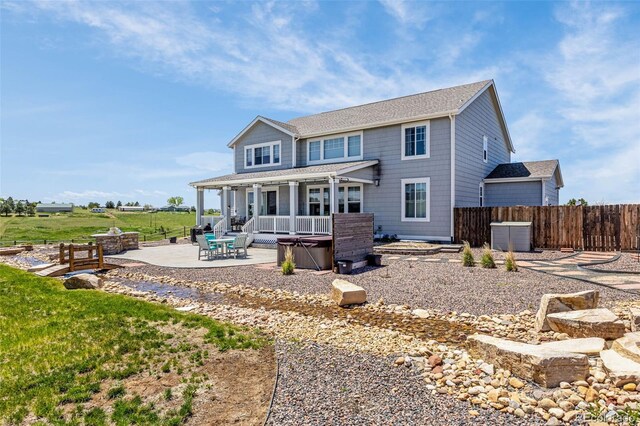 3434 Antelope Ridge Trl, Parker, CO 80138 - rear view of house featuring a hot tub, a patio, a fenced backyard, and a fire pit