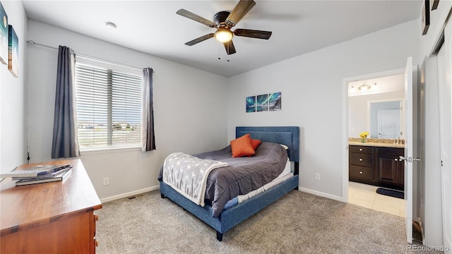 carpeted bedroom with connected bathroom and ceiling fan