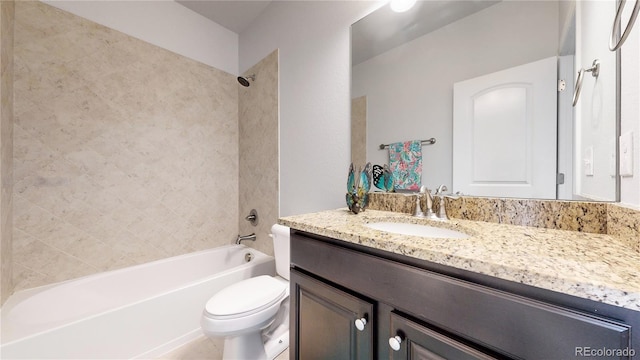 full bathroom with tiled shower / bath, vanity, and toilet