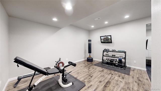 workout room with light hardwood / wood-style flooring