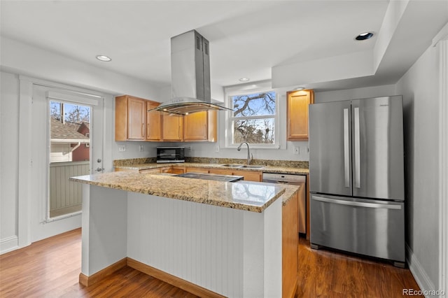 613 Pine St, Boulder, CO 80302 - kitchen featuring island exhaust hood, light stone counters, a sink, dark wood-style floors, and appliances with stainless steel finishes
