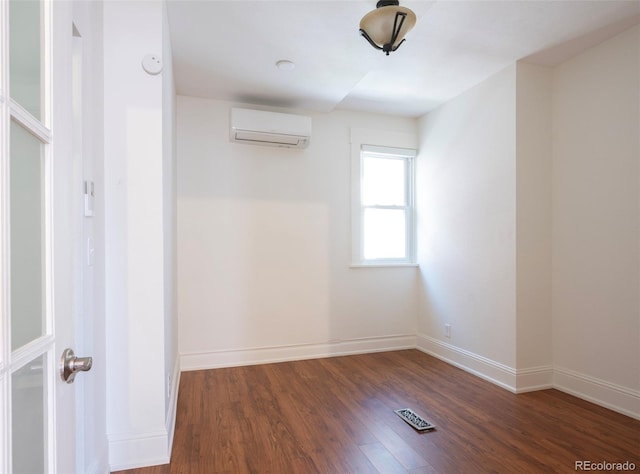 613 Pine St, Boulder, CO 80302 - empty room featuring visible vents, an AC wall unit, baseboards, and wood finished floors