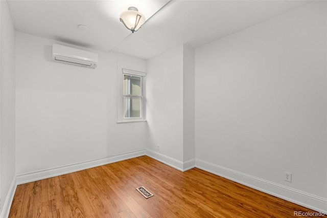 613 Pine St, Boulder, CO 80302 - unfurnished room with visible vents, light wood-style flooring, a wall mounted air conditioner, and baseboards