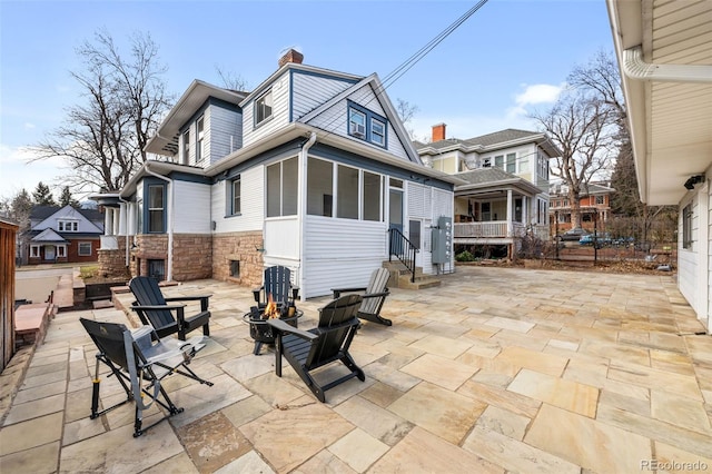 613 Pine St, Boulder, CO 80302 - rear view of house with stone siding, a fire pit, a patio, and a chimney