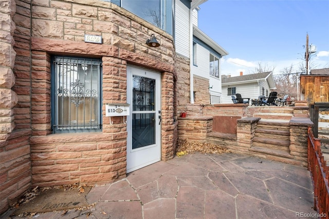 613 Pine St, Boulder, CO 80302 - property entrance featuring stone siding and a patio