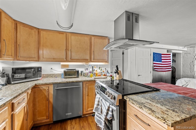 613 Pine St, Boulder, CO 80302 - kitchen with light stone counters, stainless steel appliances, wood finished floors, and island range hood