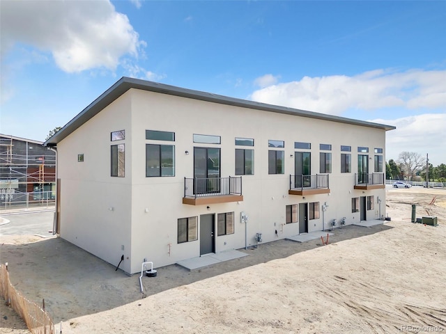 241 N Front St Unit 103, Monument, CO 80132 - rear view of property with a balcony and stucco siding