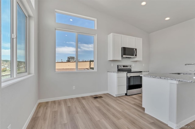 241 N Front St Unit 103, Monument, CO 80132 - kitchen featuring white cabinets, a wealth of natural light, appliances with stainless steel finishes, and a sink