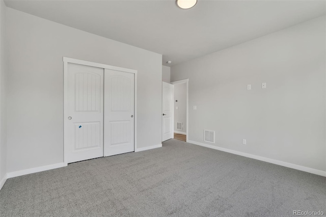 241 N Front St Unit 103, Monument, CO 80132 - unfurnished bedroom featuring baseboards, visible vents, carpet floors, and a closet