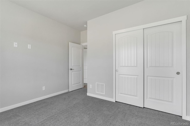 241 N Front St Unit 103, Monument, CO 80132 - unfurnished bedroom featuring a closet, carpet floors, visible vents, and baseboards