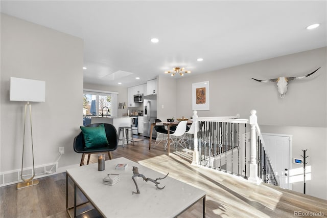 living room with sink and dark hardwood / wood-style floors