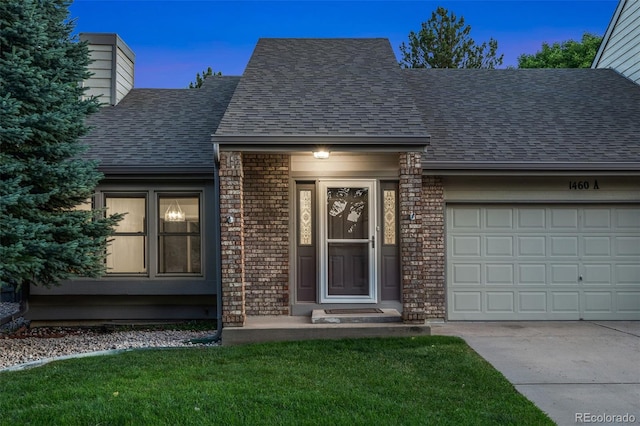 1460 Front Nine Dr Unit A, Fort Collins, CO 80525 - view of exterior entry with a shingled roof, concrete driveway, an attached garage, a chimney, and brick siding