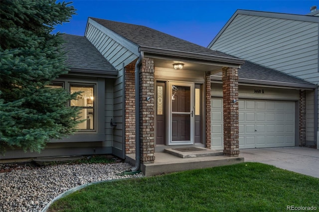 1460 Front Nine Dr Unit A, Fort Collins, CO 80525 - view of exterior entry featuring concrete driveway, an attached garage, and roof with shingles