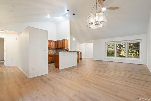 1460 Front Nine Dr Unit A, Fort Collins, CO 80525 - kitchen with open floor plan, brown cabinets, high vaulted ceiling, light wood-style floors, and a chandelier