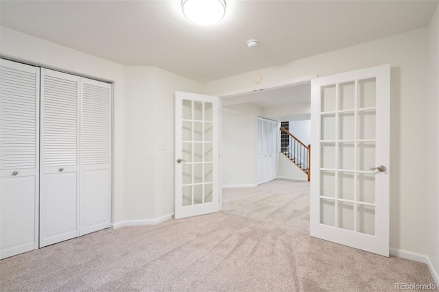 1460 Front Nine Dr Unit A, Fort Collins, CO 80525 - unfurnished room featuring french doors, carpet flooring, a smoke detector, and stairway