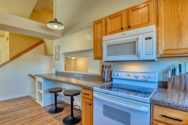 kitchen with range with electric cooktop, decorative light fixtures, and light wood-type flooring