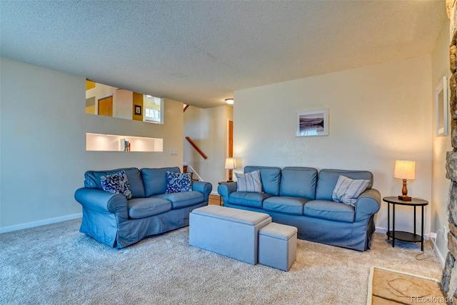 living room featuring carpet flooring and a textured ceiling