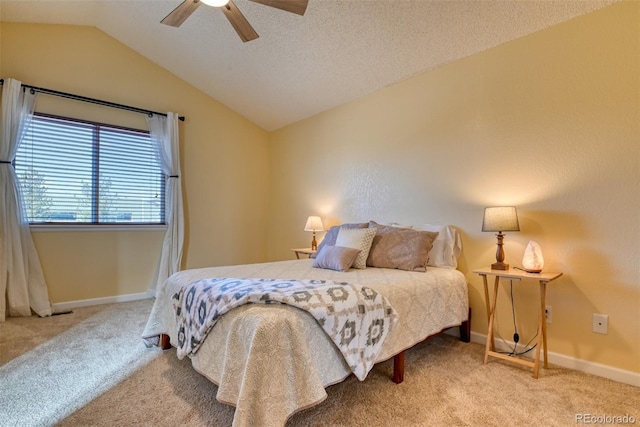 carpeted bedroom featuring ceiling fan, vaulted ceiling, and a textured ceiling