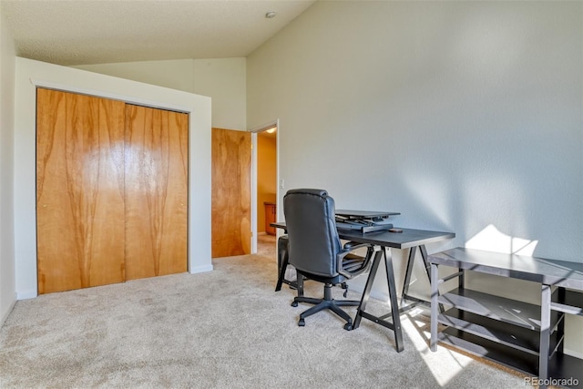 home office featuring light colored carpet and lofted ceiling