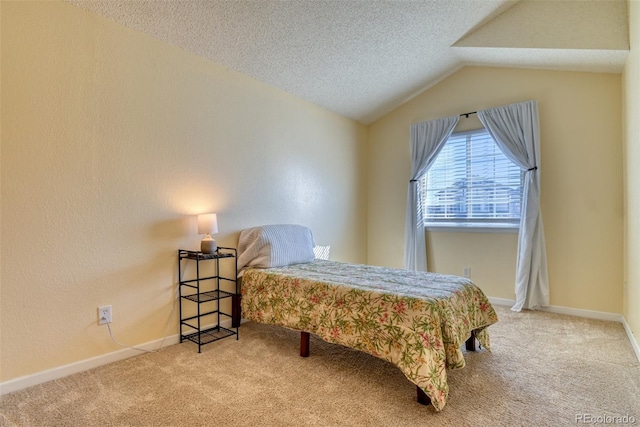 bedroom featuring carpet floors, a textured ceiling, and vaulted ceiling