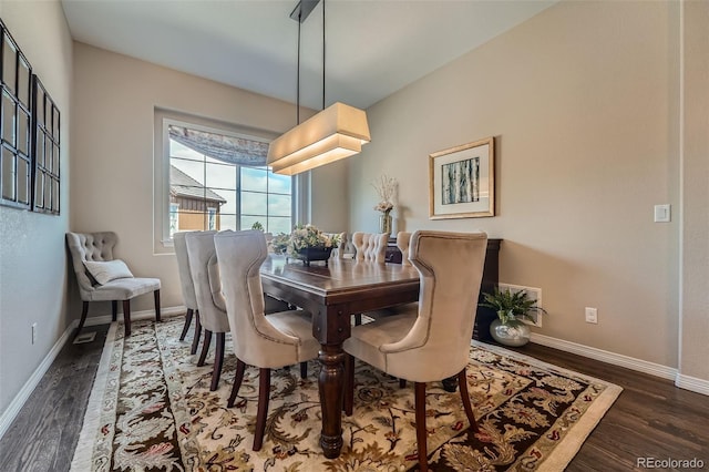 dining room featuring baseboards and wood finished floors