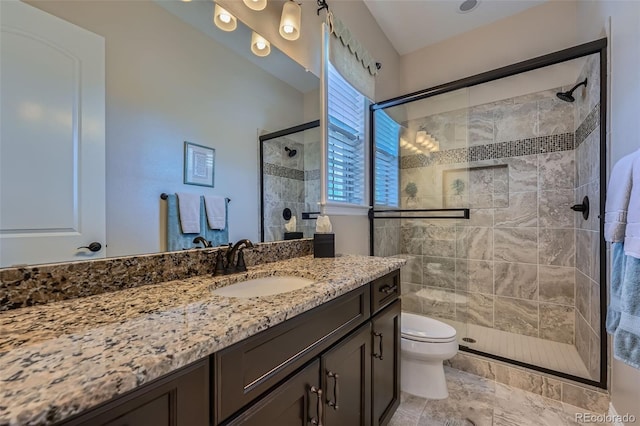 full bathroom with toilet, a shower stall, and vanity