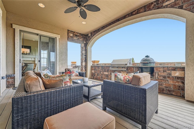 view of patio / terrace with ceiling fan, an outdoor living space, exterior kitchen, and area for grilling