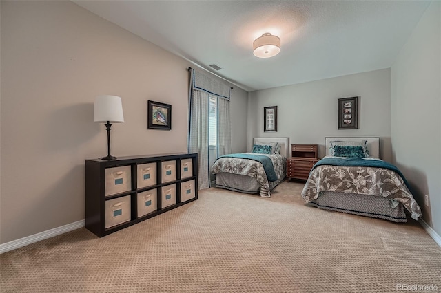 bedroom featuring baseboards, visible vents, and carpet
