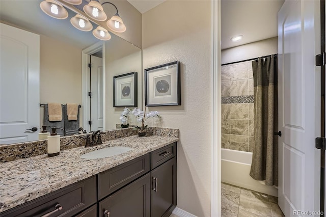 full bath featuring vanity, baseboards, and shower / bath combination with curtain
