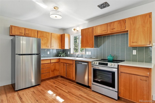 12162 W Dakota Dr, Lakewood, CO 80228 - kitchen featuring appliances with stainless steel finishes, light countertops, and tasteful backsplash