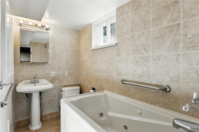 12162 W Dakota Dr, Lakewood, CO 80228 - full bathroom with a tub with jets, tile walls, tile patterned floors, a sink, and toilet