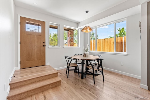 1046 N Knox Ct, Denver, CO 80204 - dining room featuring light wood-style floors and baseboards