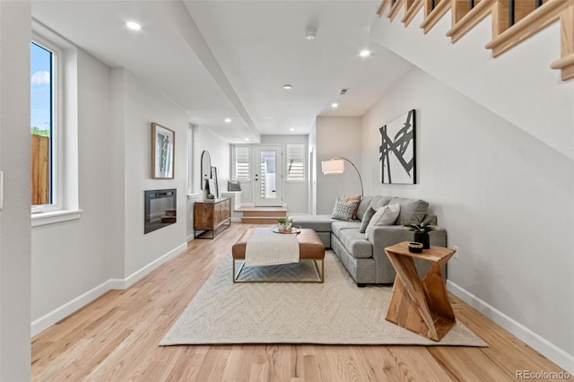 1046 N Knox Ct, Denver, CO 80204 - living room featuring light wood-type flooring, a glass covered fireplace, and recessed lighting