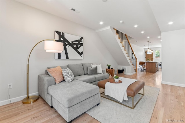 1046 N Knox Ct, Denver, CO 80204 - living area with light wood finished floors, stairs, and recessed lighting