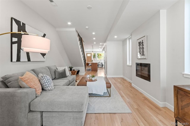 1046 N Knox Ct, Denver, CO 80204 - living area featuring light wood finished floors, recessed lighting, and a glass covered fireplace
