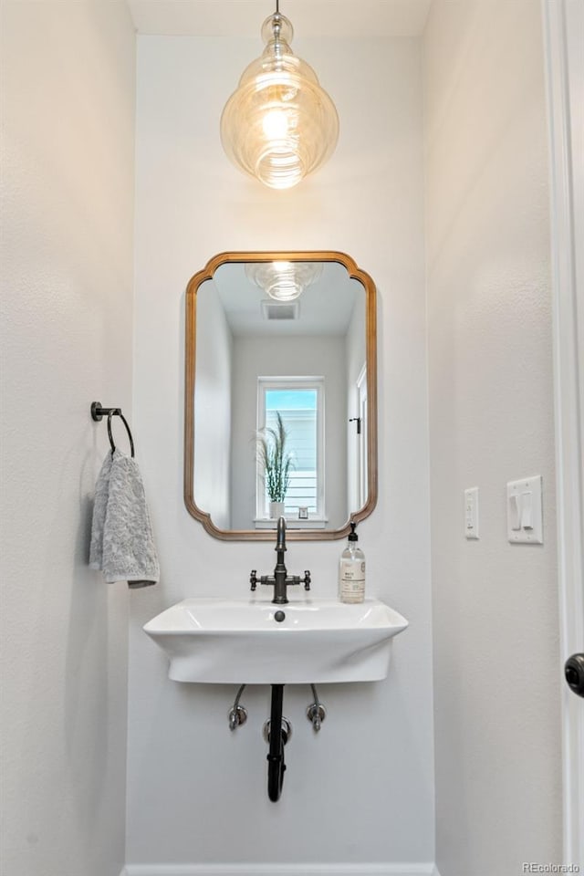 1046 N Knox Ct, Denver, CO 80204 - bathroom with baseboards and a sink