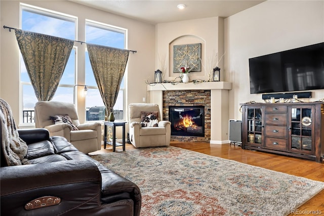 living room featuring hardwood / wood-style flooring, a healthy amount of sunlight, and a fireplace