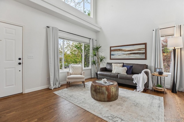4526 Lyndenwood Pt, Highlands Ranch, CO 80130 - living room featuring wood finished floors, a high ceiling, and baseboards