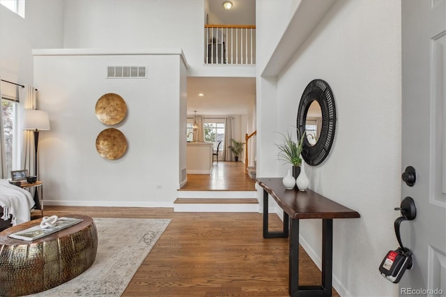 4526 Lyndenwood Pt, Highlands Ranch, CO 80130 - foyer featuring a towering ceiling, wood finished floors, and baseboards