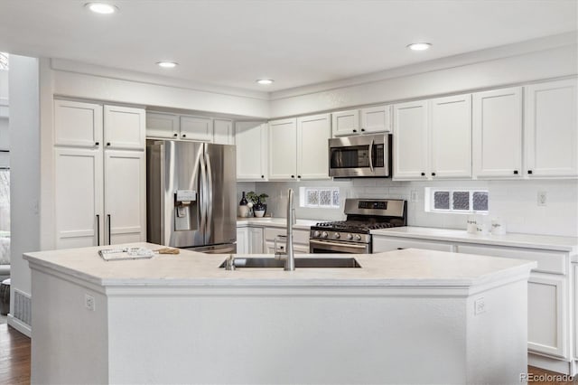 4526 Lyndenwood Pt, Highlands Ranch, CO 80130 - kitchen with appliances with stainless steel finishes, a sink, light countertops, white cabinets, and recessed lighting