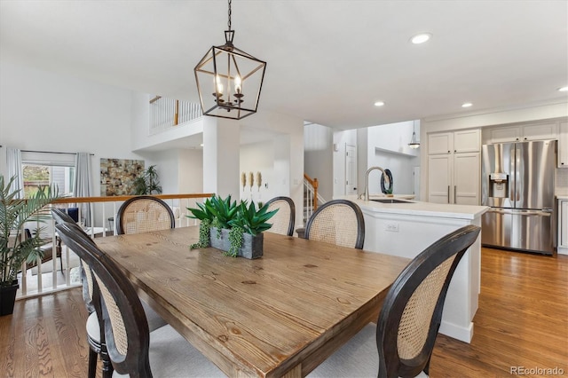 4526 Lyndenwood Pt, Highlands Ranch, CO 80130 - dining space featuring wood finished floors, a chandelier, and recessed lighting