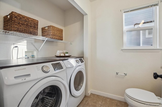 4526 Lyndenwood Pt, Highlands Ranch, CO 80130 - laundry room with washer and clothes dryer, baseboards, and light tile patterned floors