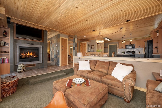 96 Mountain Side Dr Unit B61, Granby, CO 80446 - carpeted living area with a tiled fireplace, wood ceiling, and baseboards