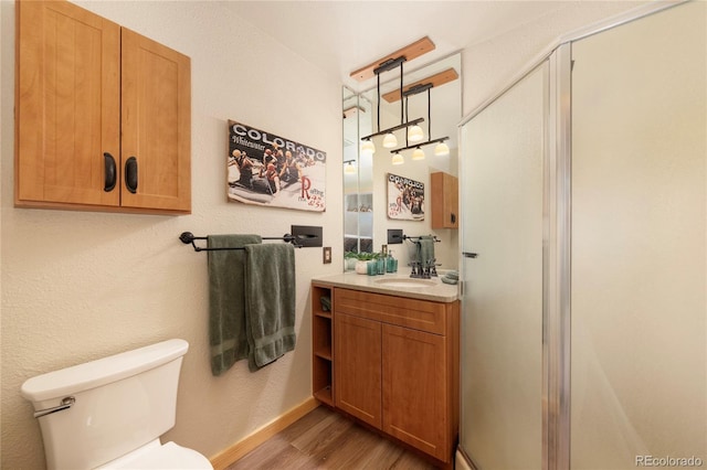 96 Mountain Side Dr Unit B61, Granby, CO 80446 - bathroom with wood finished floors, toilet, vanity, a stall shower, and baseboards