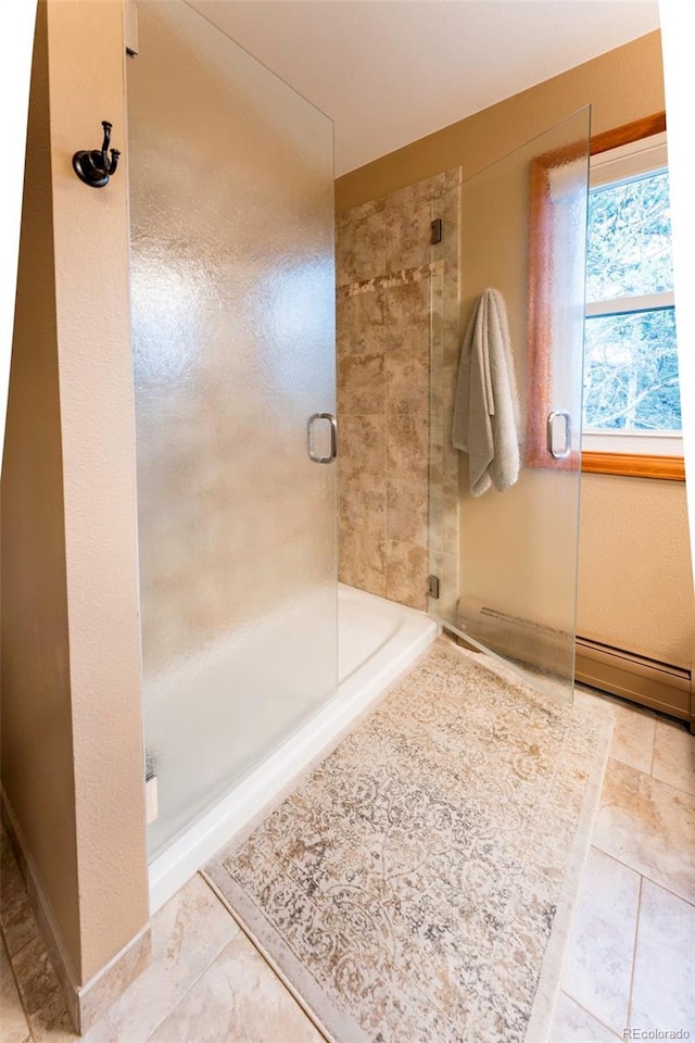 33 Sparrow Ct, Bailey, CO 80421 - bathroom with a stall shower, baseboard heating, and tile patterned floors
