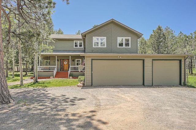 33 Sparrow Ct, Bailey, CO 80421 - view of front of property with dirt driveway, a porch, and a garage